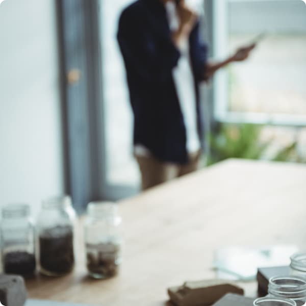 Homem em pé segura seu celular enquanto pesquisa sobre governança corporativa nas empresas.